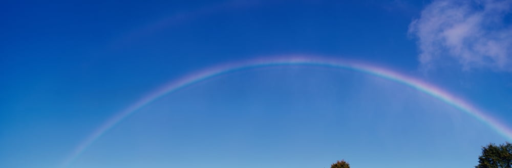 This is a rainbow against a blue sky with a few white clouds It was taken near Niagara Falls Canvas Art - Panoramic Images (36 x 12)