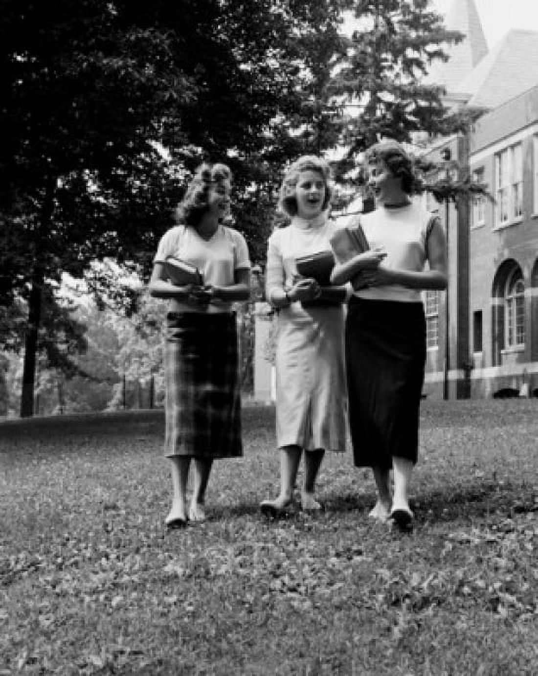 Three female students walking in front of university building and talking Canvas Art - (18 x 24)