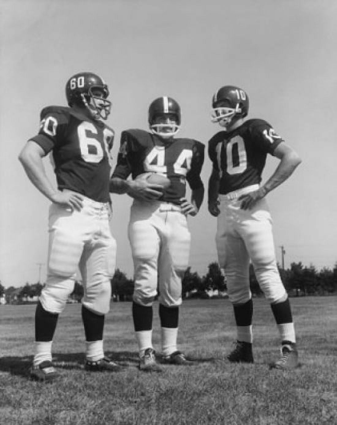 Three football players standing in a football field Canvas Art - (18 x 24)