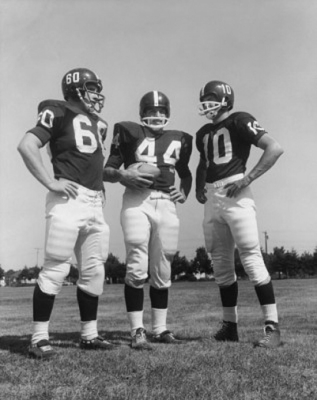 Three football players standing in a football field Canvas Art - (24 x 36)