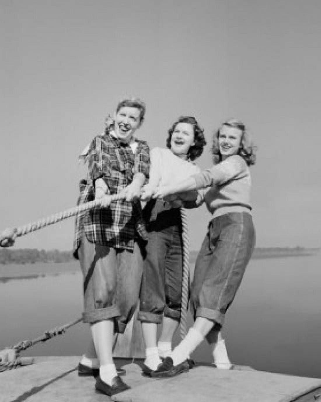 Three girls pulling rope on jetty Canvas Art - (18 x 24)