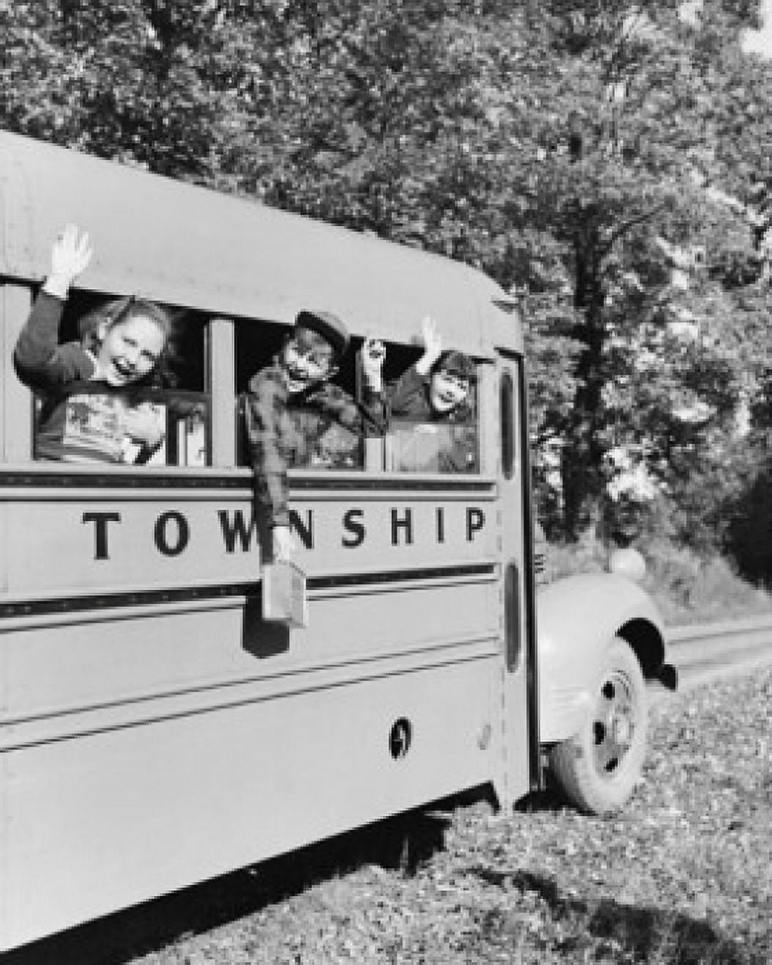 Three students waving from a school bus Canvas Art - (24 x 36)