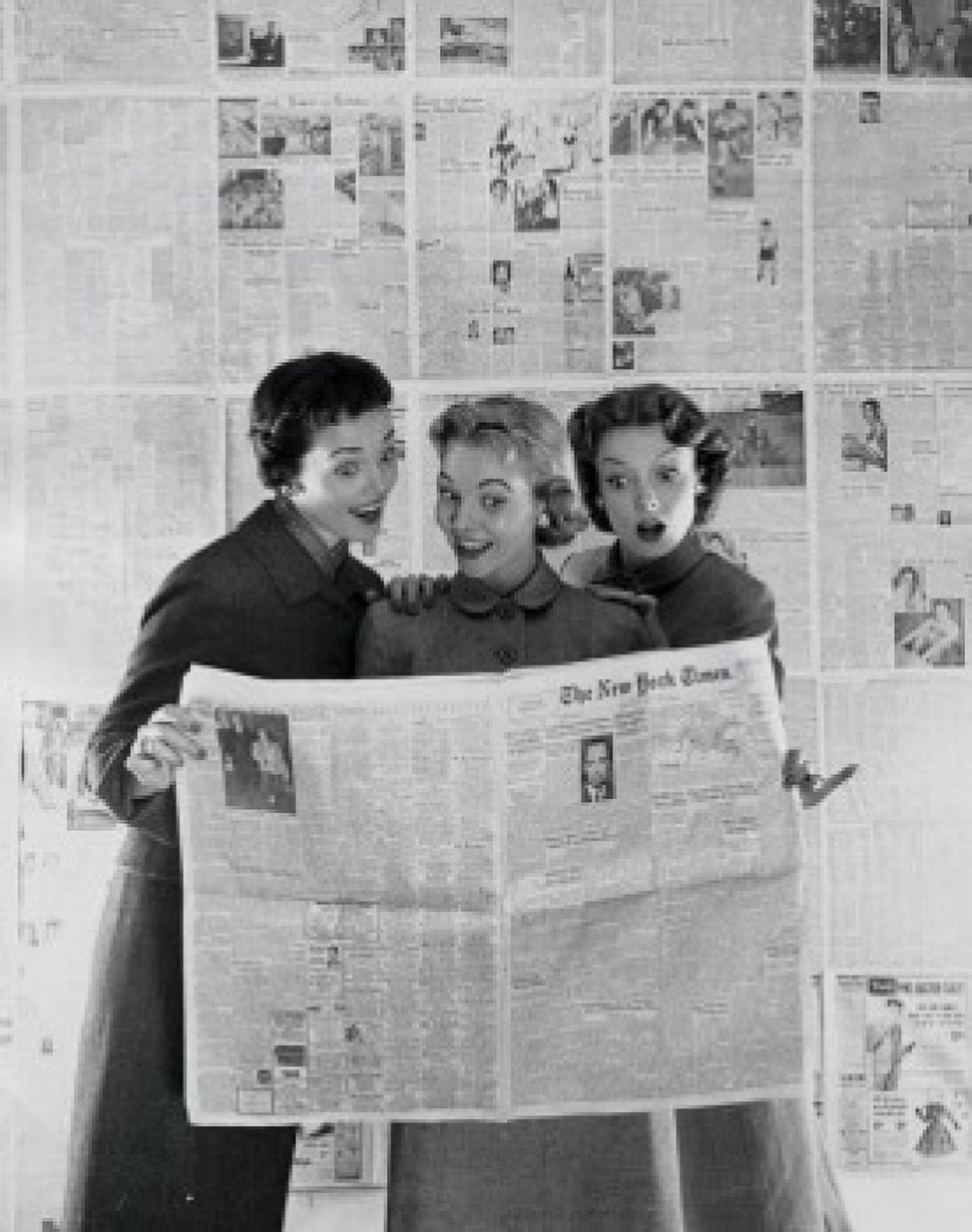 Three young women reading a newspaper Canvas Art - (18 x 24)