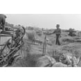 thumbnail image 1 of Threshing Wheat In Central Ohio. A Farmer Forks Wheat Into The Feeding Belt Of Stationary Threshing Machine. He Stands On A Horse Drawn Wagon Loaded With Cut Grain From The Nearby Field. August 1938., 1 of 1