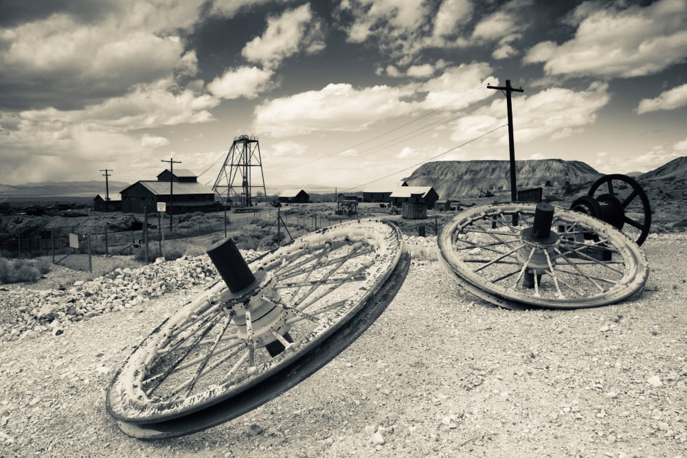 Tire with Desert Queen hoist house and mine in the background Tonopah Historic Mining Park Tonopah Great Basin Nevada USA Canvas Art - Panoramic Images (36 x 12)