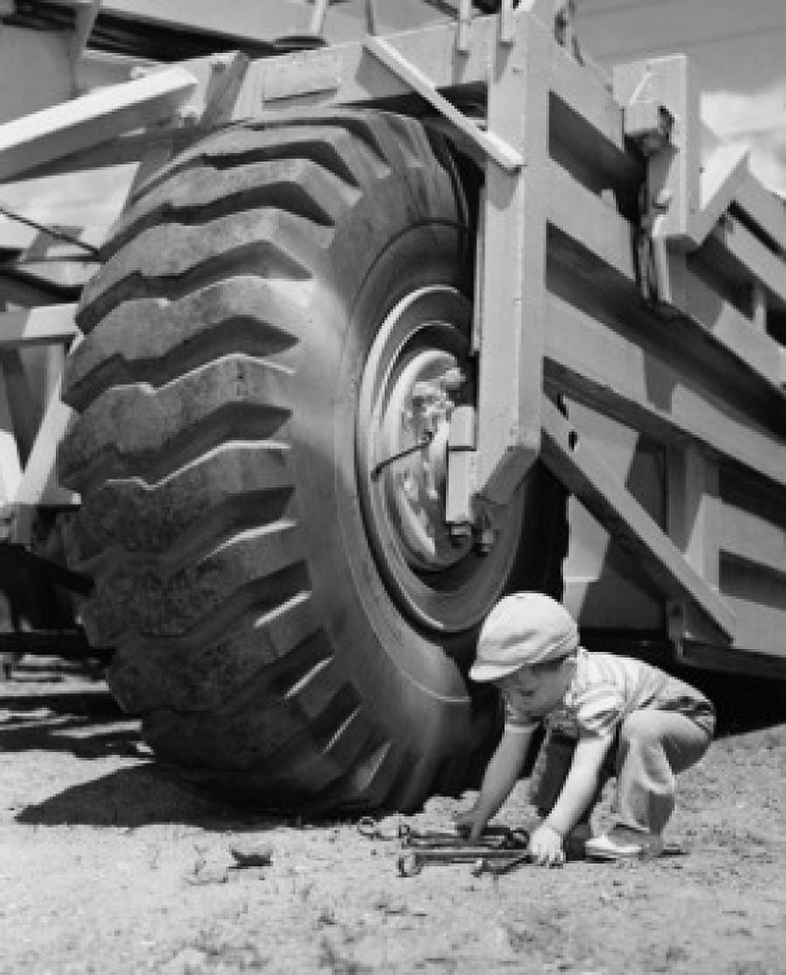 Toddler picking up wrenches Canvas Art -  (18 x 24)