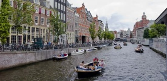 Tourboats in a canal Amsterdam Netherlands Canvas Art - Panoramic Images (24 x 12)
