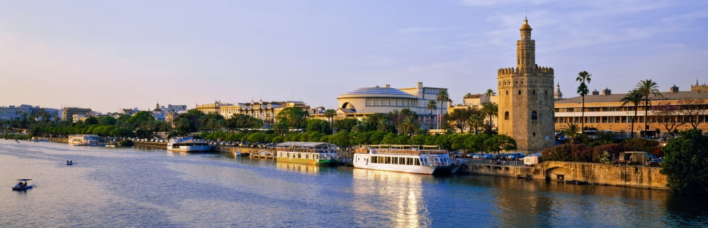 Tourboats in a river Guadalquivir River Seville Seville Province Andalusia Spain Canvas Art - Panoramic Images (12 x 36)