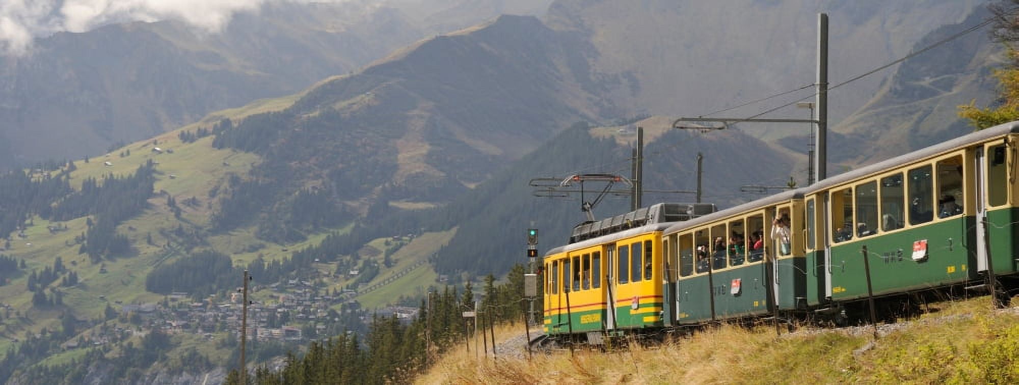 Tourist train passing through hills Murren Kleine Scheidegg Bernese Oberland Bern Switzerland Canvas Art - Panoramic Images (27 x 9)