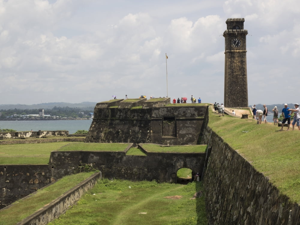 Tourists along rampart of Galle Fort Clock tower in rear Galle Southern Province Sri Lanka Canvas Art - Panoramic Images (12 x 16)