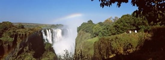 Tourists at a viewing point looking at the rainbow formed over Victoria Falls Zimbabwe Canvas Art - Panoramic Images (36 x 13)