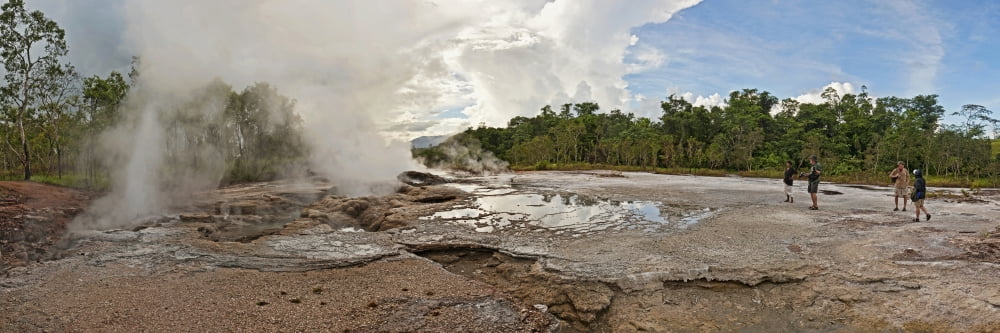 Tourists looking at a hot spring Fergusson Island Papua New Guinea Canvas Art - Panoramic Images (27 x 9)