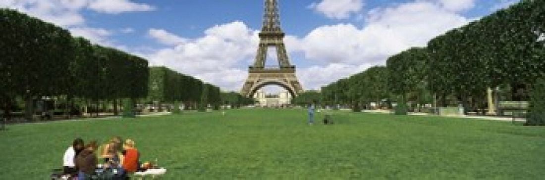 Tourists sitting in a park with a tower in the background Eiffel Tower Paris Ile-de-France France Canvas Art - Panoramic Images (18 x 6)