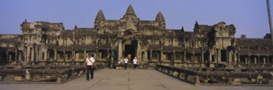 Tourists walking in front of an old temple Angkor Wat Siem Reap Cambodia Canvas Art - Panoramic Images (18 x 6)