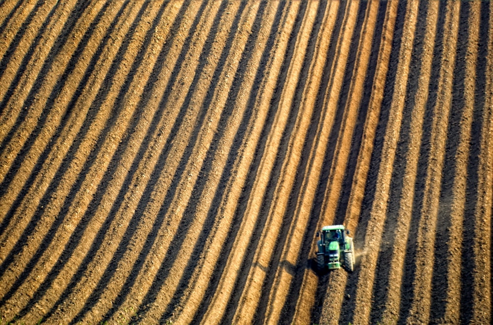 Tractor Plowing A Field Canvas Art - John Short Design Pics (17 x 11)