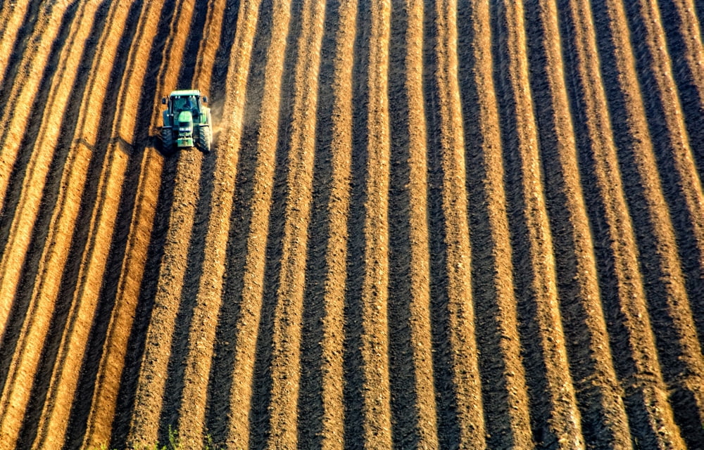 Tractor Plowing A Field Canvas Art - John Short Design Pics (34 x 22)