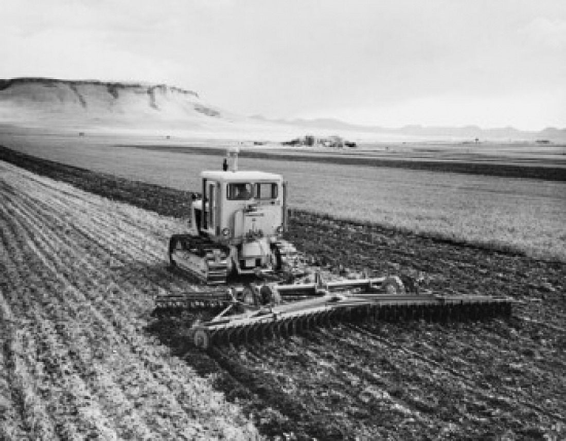 Tractor pulling a harrow in a wheat field Canvas Art - (24 x 36)