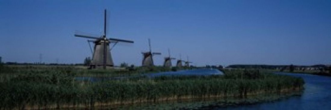 Traditional windmills at a riverbank Kinderdijk Rotterdam Netherlands Canvas Art - Panoramic Images (18 x 6)