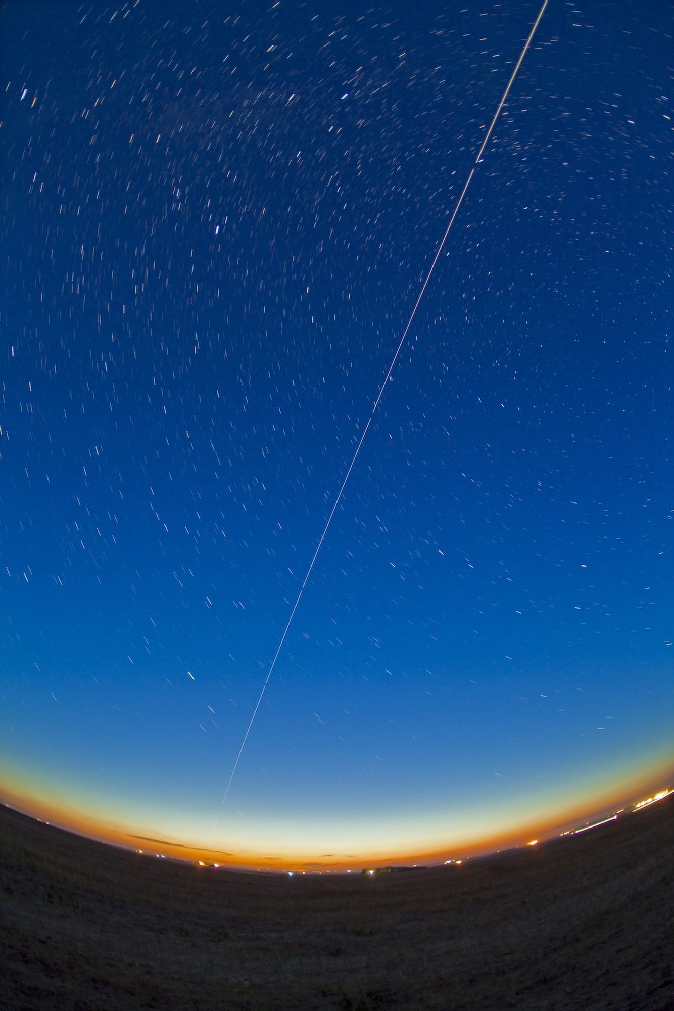 Trail of the International Space Station coming out of the western twilight Canvas Art - Alan DyerStocktrek Images (23 x 35)