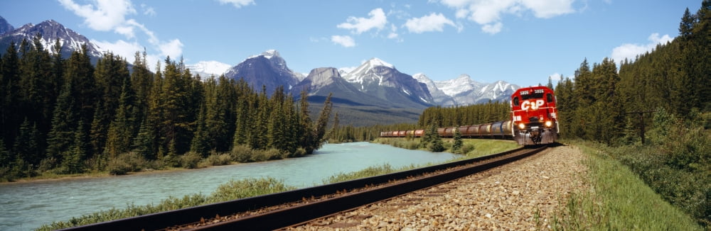 Train on a railroad track Morants Curve Banff National Park Alberta Canada Canvas Art - Panoramic Images (27 x 9)