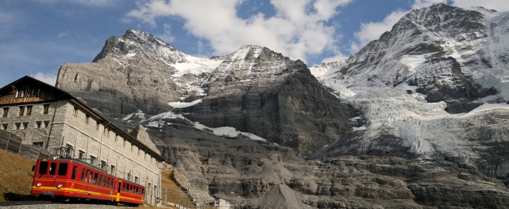 Train passing through Eigergletscher Railway Station near Eiger and Monch mountains Kleine Scheidegg Bernese Oberland Bern Switzerland Canvas Art - Panoramic Images (36 x 12)