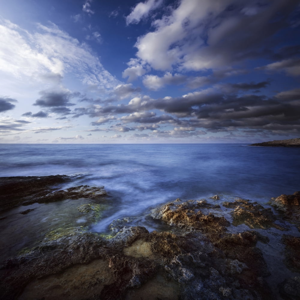 Tranquil lake and rocky shore against cloudy sky Crete Greece Canvas Art - Evgeny KuklevStocktrek Images (29 x 29)