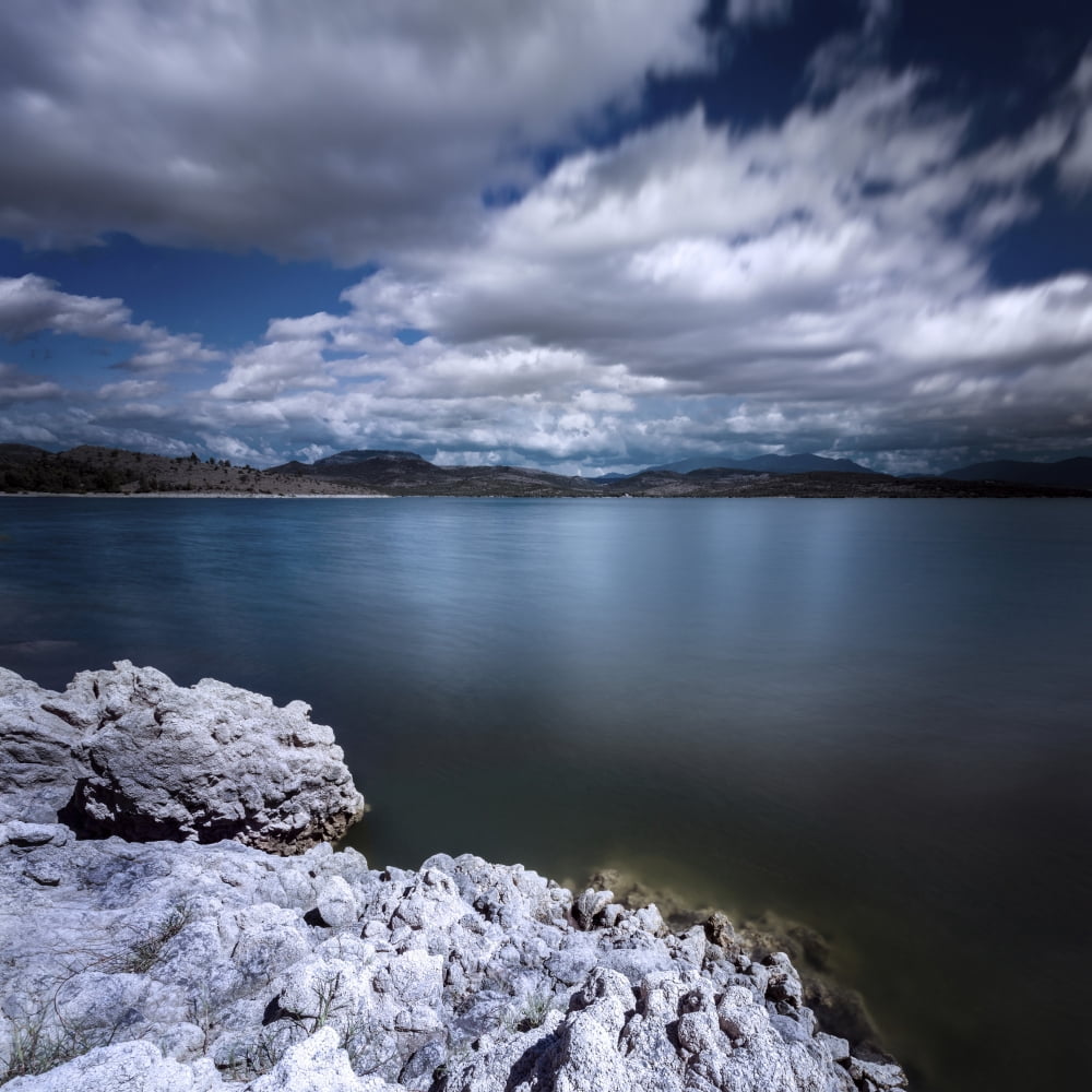 Tranquil lake and rocky shore against cloudy sky Sardinia Italy Canvas Art - Evgeny KuklevStocktrek Images (29 x 29)