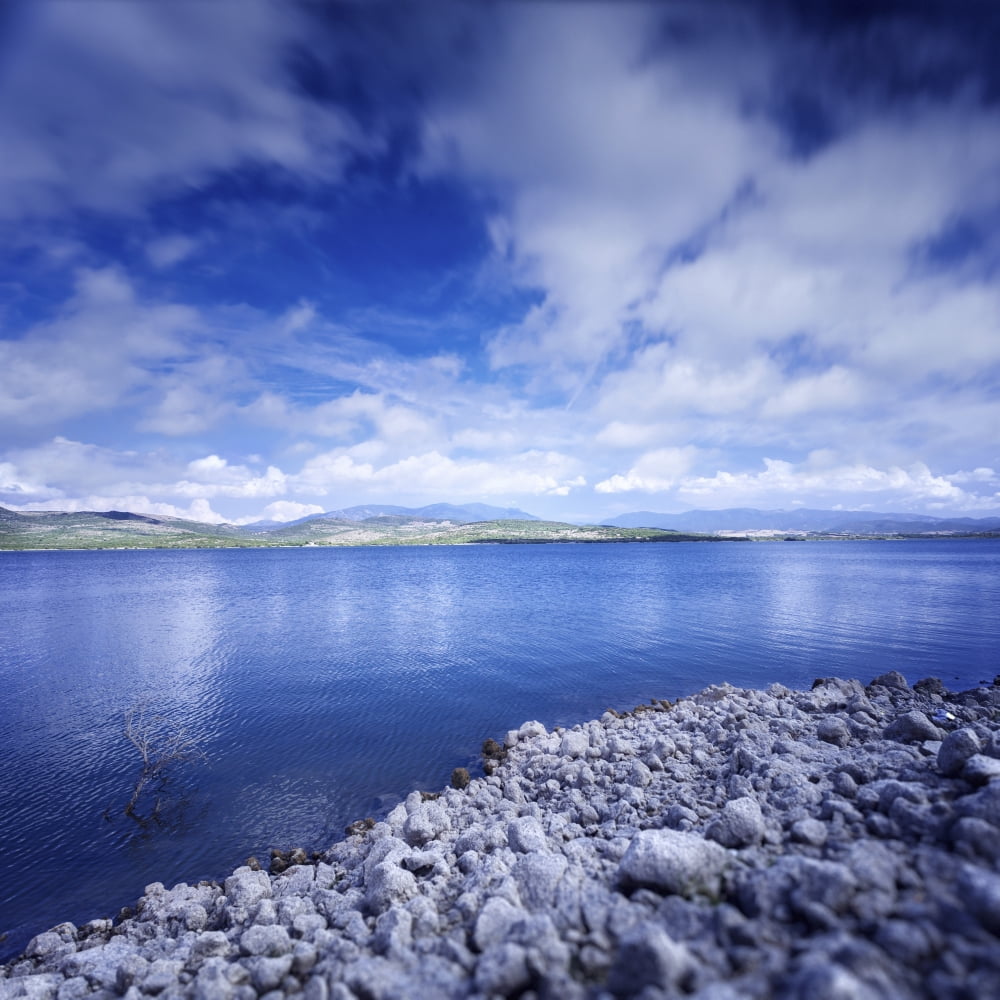 Tranquil lake and rocky shore against cloudy sky Sardinia Italy Canvas Art - Evgeny KuklevStocktrek Images (29 x 29)