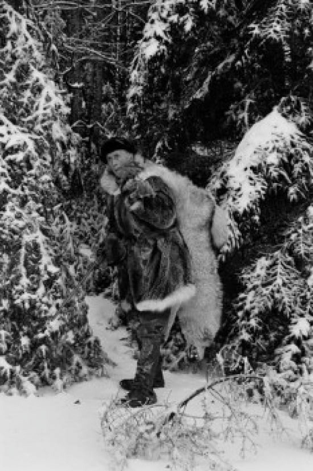 Trapper carrying dead wolf Canvas Art - (24 x 36)