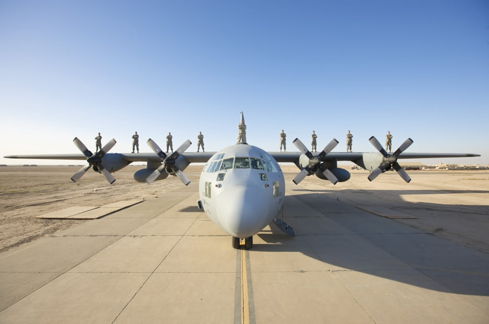 Troops stand on the wings of a C-130 Hercules at parade rest Canvas Art - Terry MooreStocktrek Images (18 x 12)