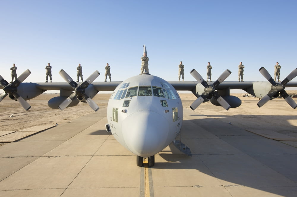 Troops stand on the wings of a C-130 Hercules at parade rest Canvas Art - Terry MooreStocktrek Images (18 x 12)