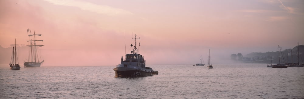 Tugboat and tall ships in the ocean at sunrise Baie De Douarnenez Finistere Brittany France Canvas Art - Panoramic Images (36 x 12)