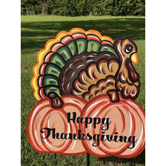 Turkey Sits on two pumpkins
