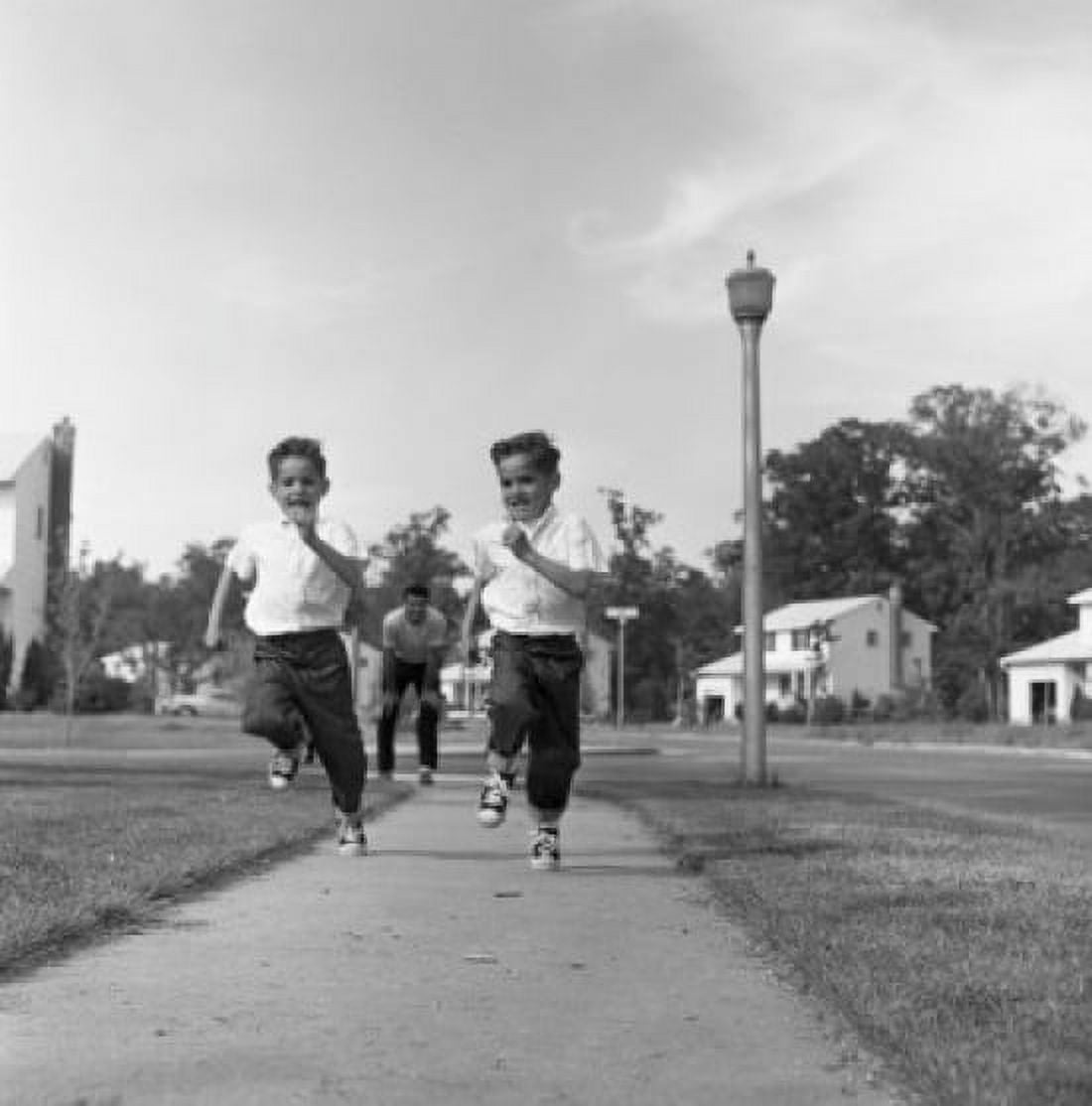 Twin boys running on pavement Canvas Art -  (24 x 36)