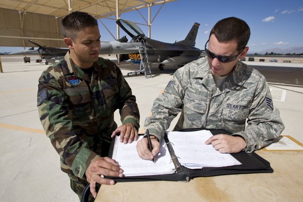 Two F-16 crew chiefs go over paperwork between missions Canvas Art - HIGH-G ProductionsStocktrek Images (36 x 24)