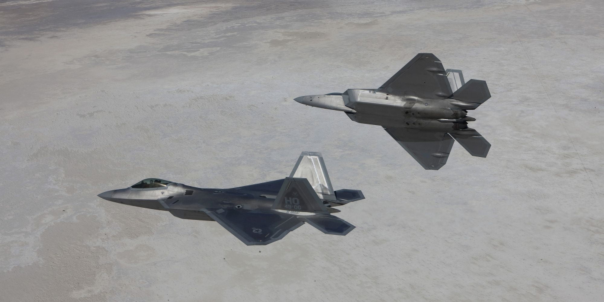 Two F-22 Raptors on a training mission over New Mexico Canvas Art - HIGH-G ProductionsStocktrek Images (40 x 20)