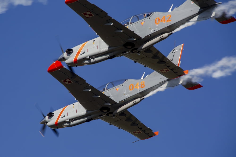 Two PZL-130 Orlik trainers of the Polish Air Force in flight Canvas Art - Timm ZiegenthalerStocktrek Images (18 x 12)