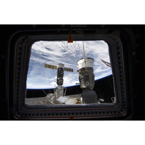 Two Russian spacecraft docked with the International Space Station as seen from Space Shuttle Discoverys flight deck window Canvas Art - Stocktrek Images (34 x 23)