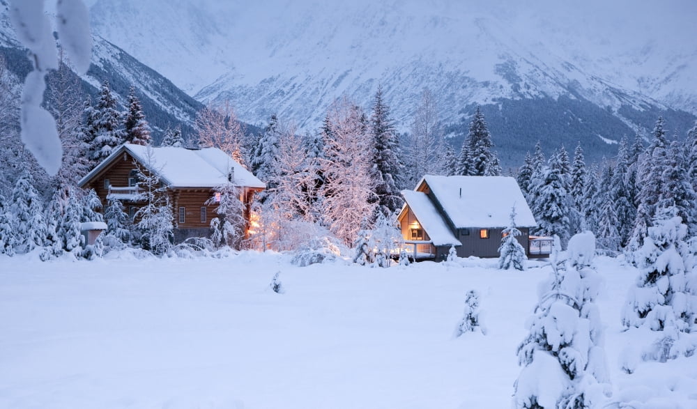 Two Snowcovered Homes In A Wintry Meadow At Dawn With Inside Lights On Girdwood Southcentral Alaska Canvas Art - Jeff Schultz Design Pics (38 x 22)
