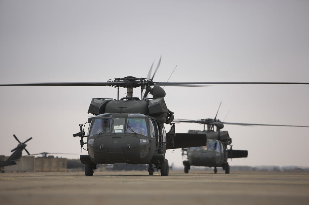 Two UH-60 Black Hawks taxi out for a mission over northern Iraq Canvas Art - Terry MooreStocktrek Images (35 x 23)