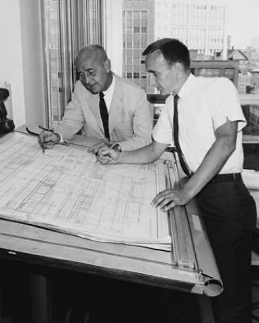 Two architects discussing a blueprint Canvas Art - (24 x 36)