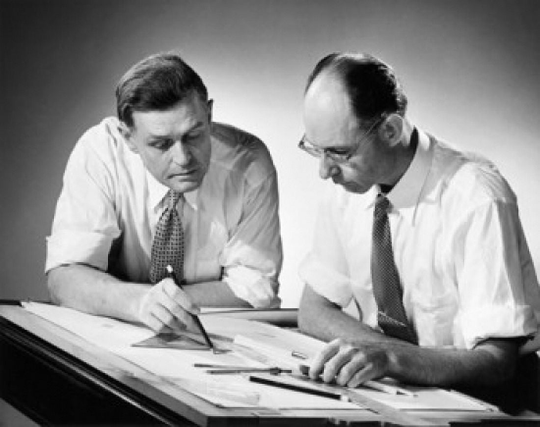 Two architects discussing a blueprint Canvas Art - (24 x 36)