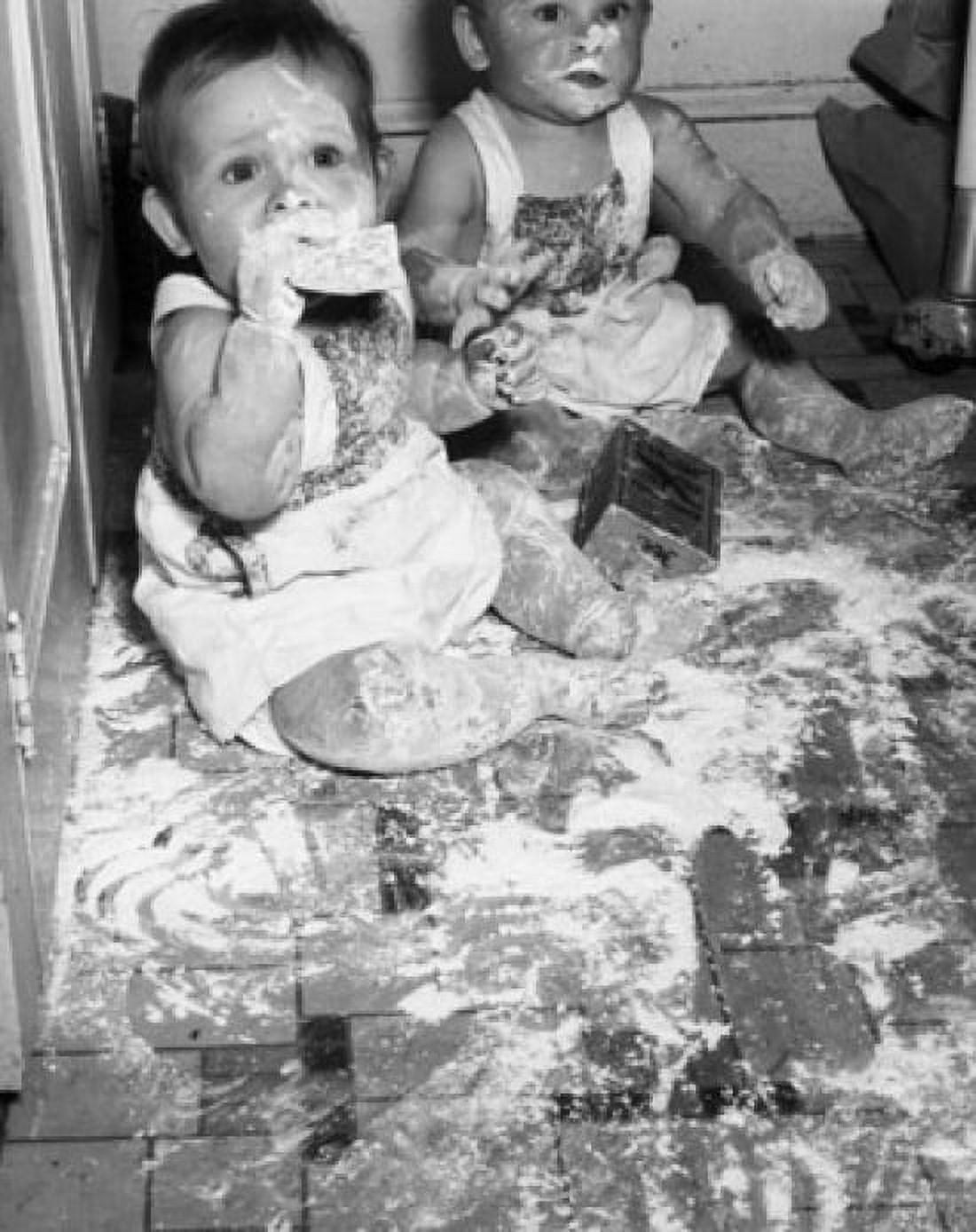 Two babies sitting on the floor covered in flour Canvas Art - (24 x 36)