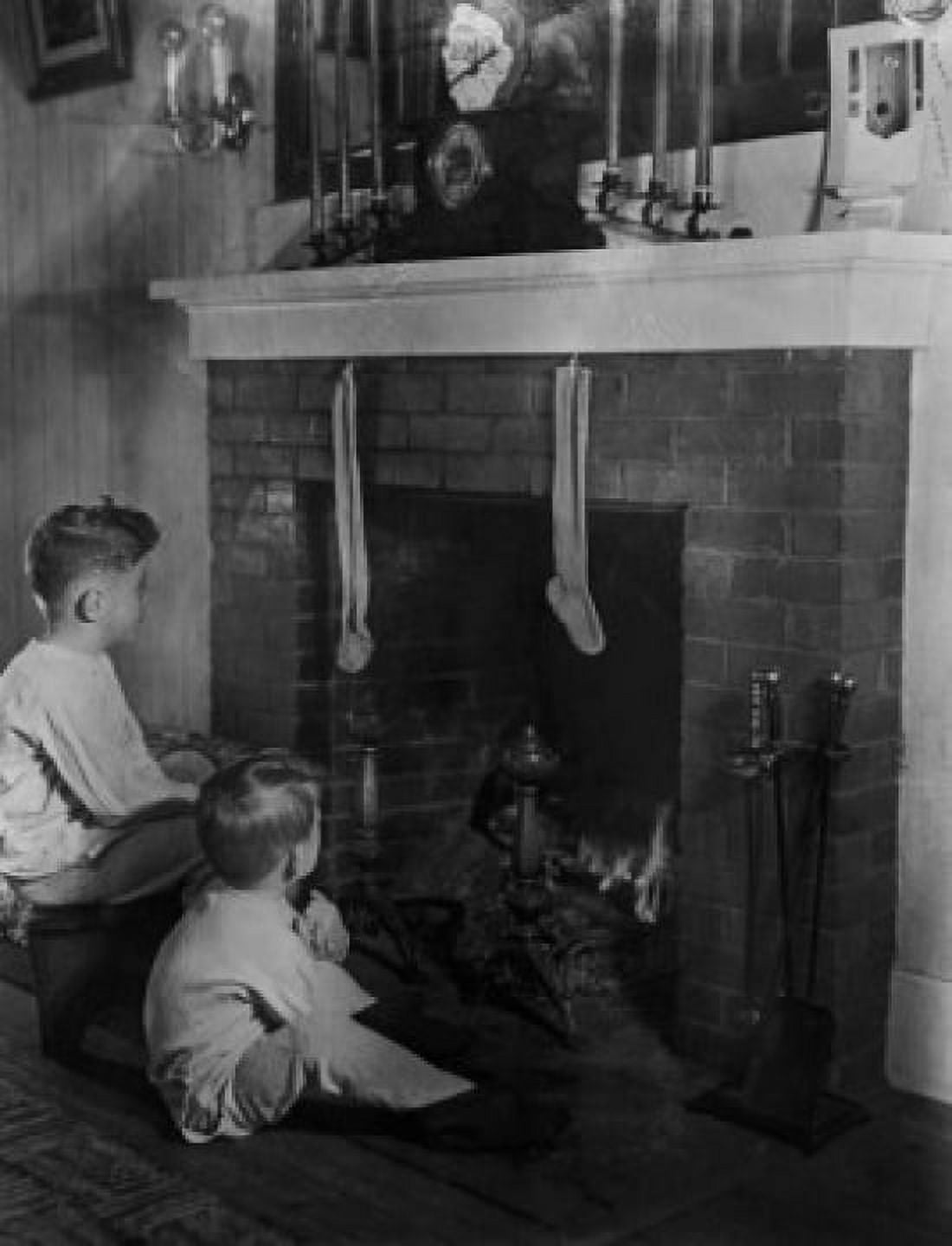 Two boys (4-5) sitting in front of fireplace looking at christmas stockings Canvas Art - (18 x 24)