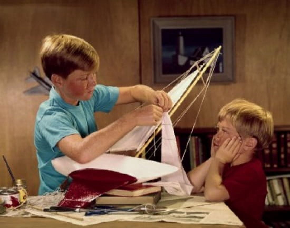 Two boys assembling a model of sailboat Canvas Art - (18 x 24)