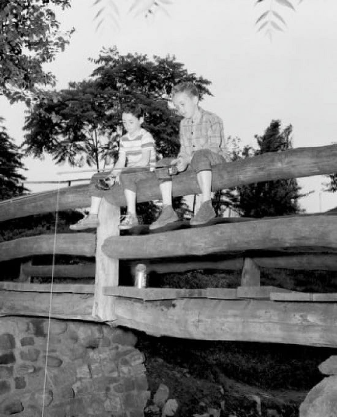 Two boys fishing from wooden bridge Canvas Art - (18 x 24)