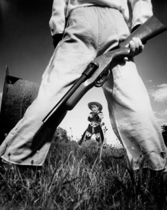 Two boys having a toy gun duel in a field Canvas Art - (24 x 36)