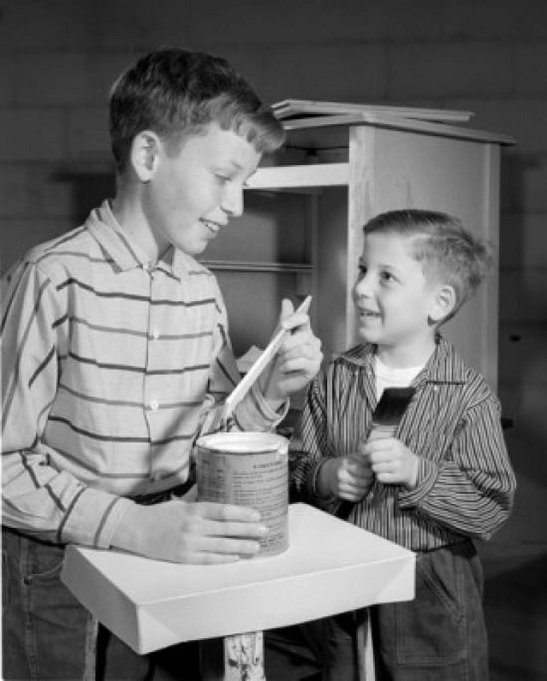 Two boys holding paint brushes in home Canvas Art - (18 x 24)