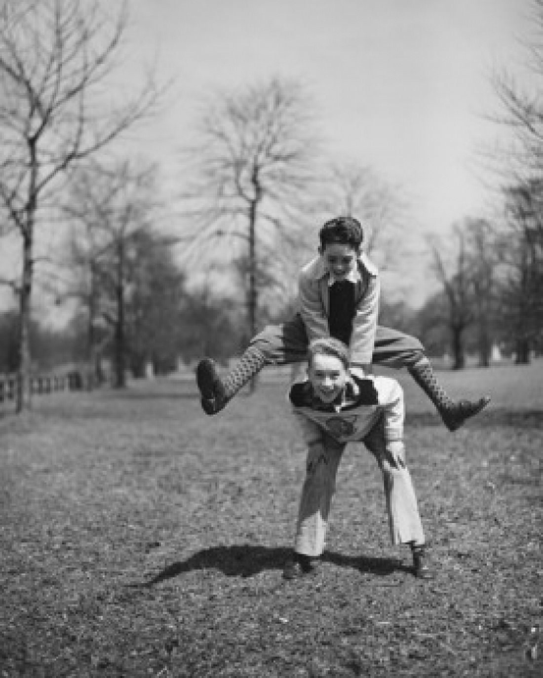Two boys leapfrogging in park Canvas Art - (18 x 24)