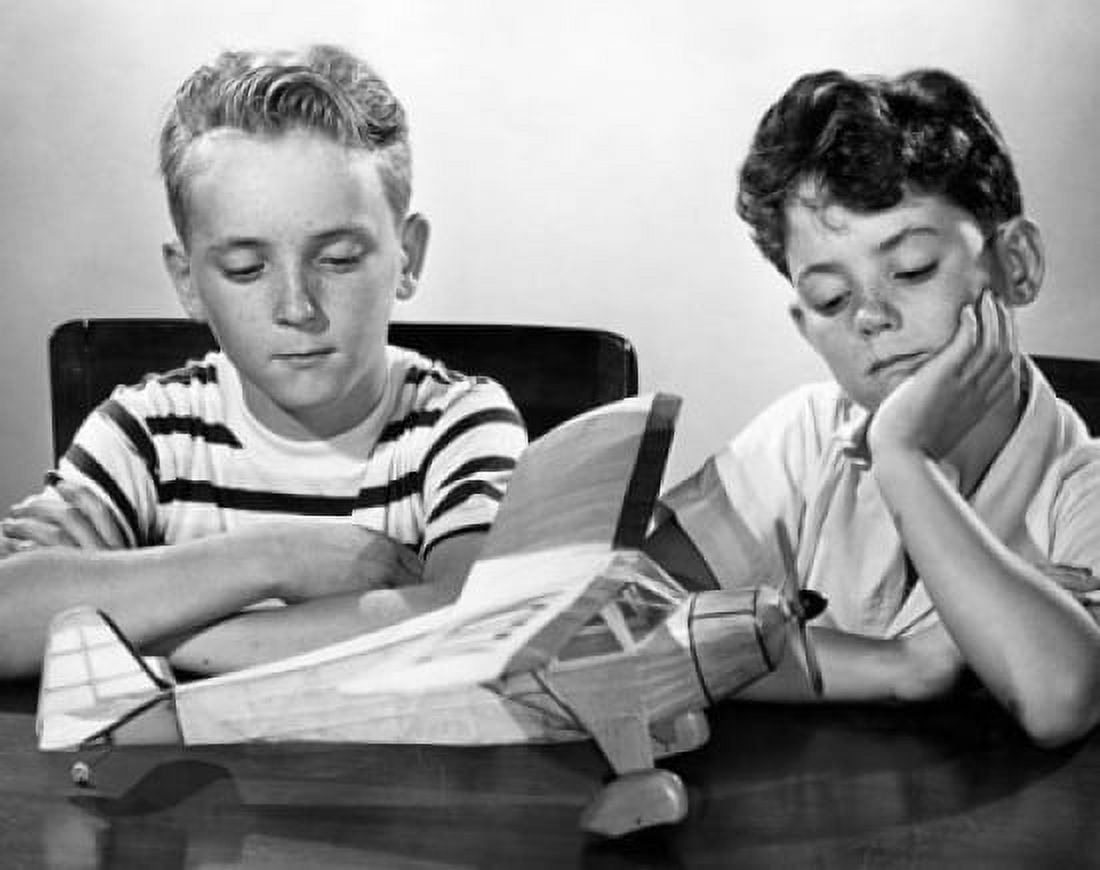 Two boys looking at a model airplane and thinking Canvas Art - (18 x 24)